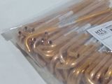 a bag of gold toothpicks sitting on a white table