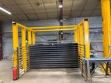 a large stack of black and yellow plates in a warehouse
