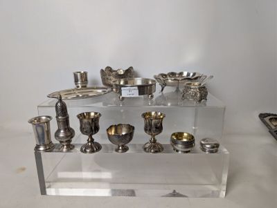 a display of silver objects on a clear shelf