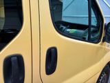 a yellow van that is parked on the side of the street