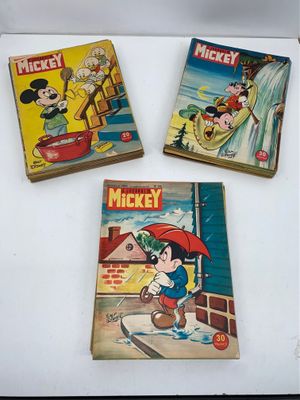 three mickey mouse books sitting on top of a white table