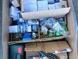 une boîte remplie d'objets hétéroclites posée sur le sol