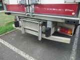 a red and white fire truck parked in a parking lot