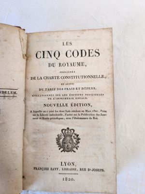 an open book with a picture of a crown on top of it