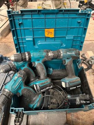 a blue tool box filled with power tools on the ground