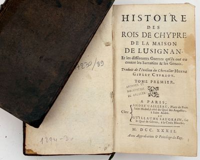 an old book sitting on top of a white table
