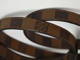 a brown and black belt that is on a table