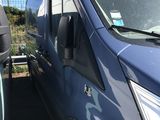 a blue van that is parked in a parking lot
