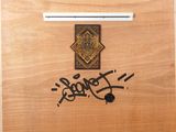 a wooden box with graffiti written on it on the floor
