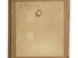 an old picture of a ring on a piece of cardboard