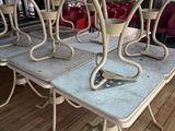 a table that has a bunch of chairs on it