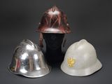 two helmets are sitting next to each other on a black surface
