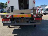 a white truck with a red and yellow stripe on the back of it