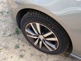 a close up of a car ' s tire on a dirt road