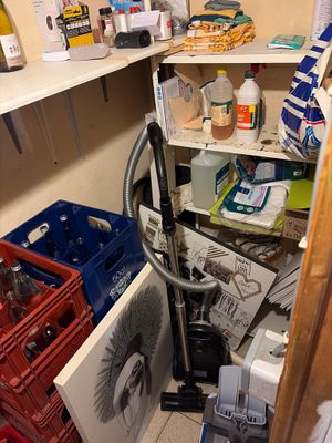 a cluttered pantry with many items on the shelves