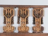 three wooden carvings on a shelf on a table