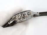 a close up of a watch being held by a glove