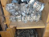 several pieces of metal are stacked on top of a wooden shelf