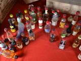 many bottles of alcohol sitting on a red table