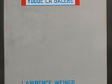 a close up of a white book with blue writing on it