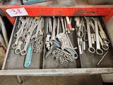 a drawer full of tools that are sitting on a table
