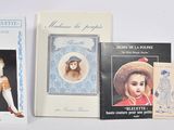 three books are lined up on a white surface one is of a woman and the other is of a man