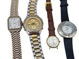 several different types of watches are lined up on a white surface