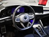 a steering wheel and dashboard of a car on display at a car show