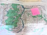 a map on a table with a pair of scissors on it