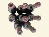 bottles of wine are arranged in a circle on a white surface