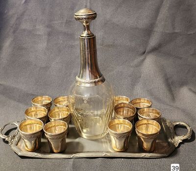 a silver tray with cups and a decanter on it