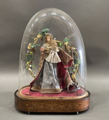 a figurine of a woman under a glass dome