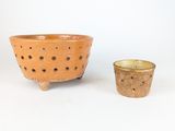 deux petits bols et une petite tasse posés sur une surface blanche