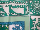 a close up of a green and white cloth with a picture of a horse