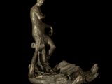 statue of a man and a dog on a rock with a black background
