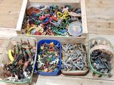 a box full of assorted toys on a wooden table