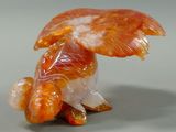 a figurine of a fish with an umbrella on it ' s head