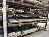 a rack of metal items in a warehouse with pallets