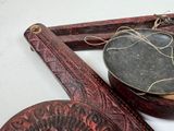 a wooden spoon and a bowl sitting on a table