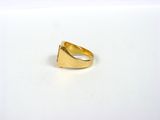 a close up of a gold ring on a white surface