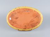 an orange and yellow plate sitting on top of a gray surface