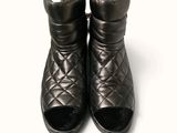 a pair of black shoes that are on a white surface