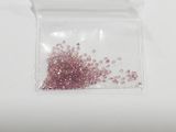 a small bag with some pink beads inside of it