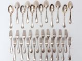 a lot of silver spoons and forks on the table