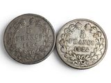 two old silver coins with the names of different countries on them