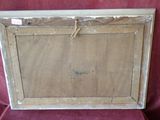 an old picture frame with a rope hanging from it on a red chair