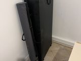 a black refrigerator sitting in a corner next to a white wall