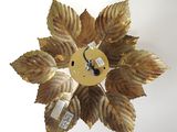 a clock that is hanging on the wall in the shape of a flower