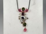 pink tourmaline and green tourmaline pendant on a black cord necklace