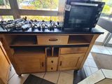 a kitchen with a stove, microwave, and cabinets in it